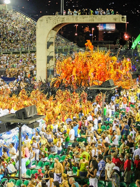 Sambadrome parade with colorful costumes and full grandstands in Rio de Janeiro.
