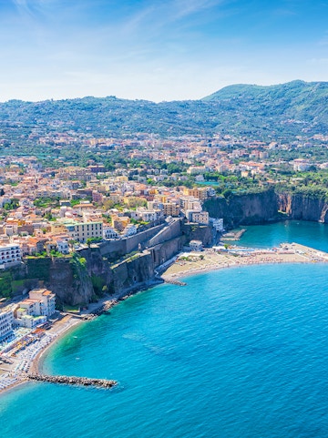 Aerial view of Sorrento coastline with cliffs and buildings, part of Rome to Naples tours.