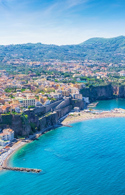 Aerial view of Sorrento coastline with cliffs and buildings, part of Rome to Naples tours.