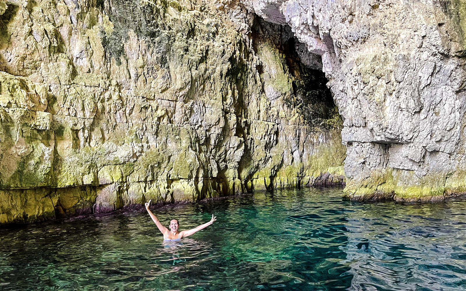 Swimmer enjoying Dafina Bay near Haxhi Ali Cave, Albania.