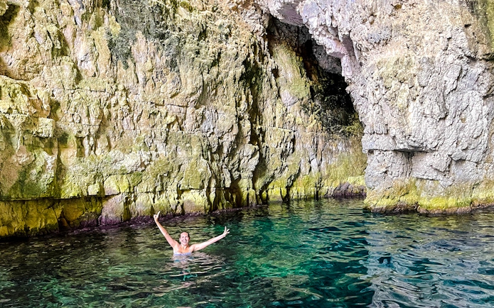 Swimmer enjoying Dafina Bay near Haxhi Ali Cave, Albania.