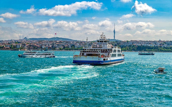 Ferry on Bosphorus Strait with Istanbul skyline during Bosphorus Golden Horn Cruise tour.