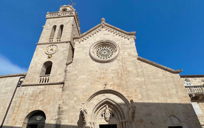 Cathedral of St. Mark facade with clock tower in Korcula, Croatia.
