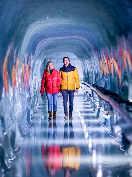 Couple walking through ice tunnel at Jungfraujoch, Switzerland.