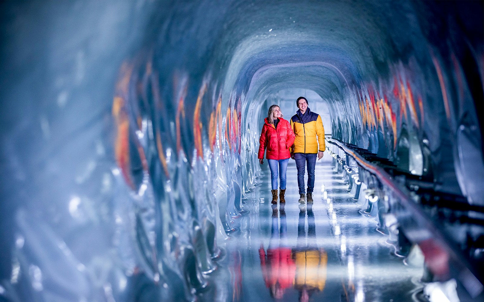 Couple walking through ice tunnel