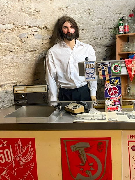 Prague Beer Museum interior with vintage bar setup and memorabilia.
