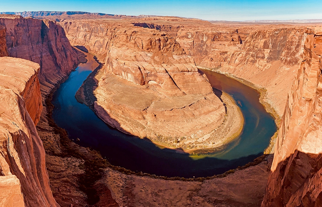 Aerial view of the stunning Horseshoe Bend during a helicopter tour, showcasing the unique natural beauty of this popular tourist attraction
