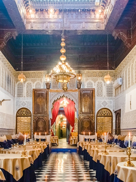 Dar Essalam Moroccan restaurant interior with ornate decor and candlelit tables.