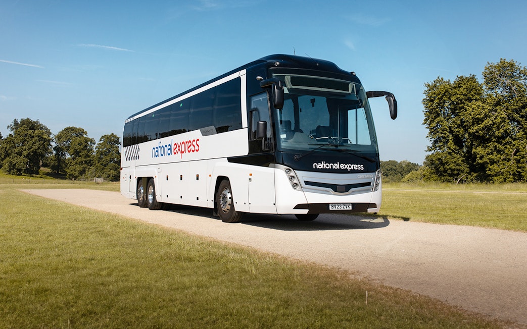 National Express bus traveling on a countryside road.