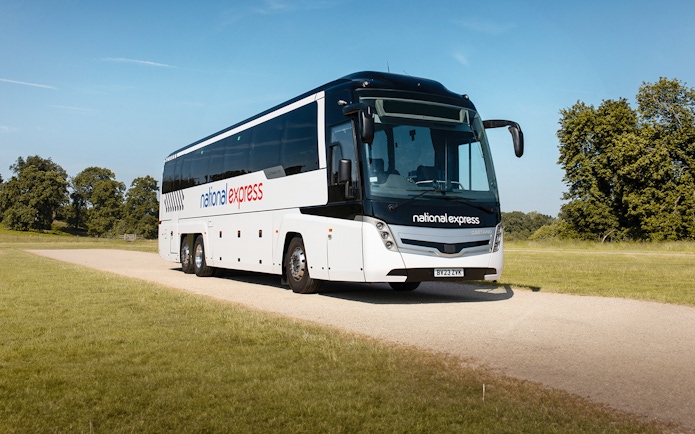 National Express bus traveling on a countryside road.