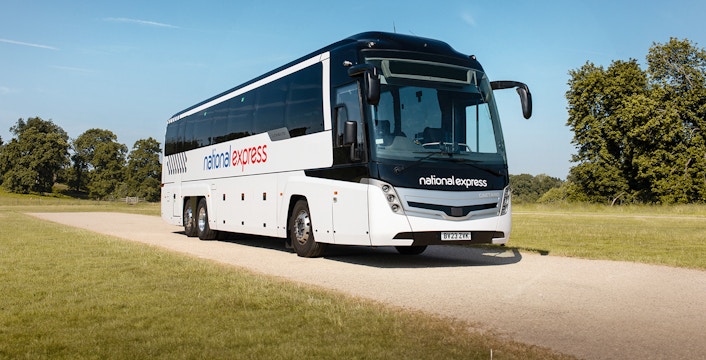 National Express bus traveling on a countryside road.