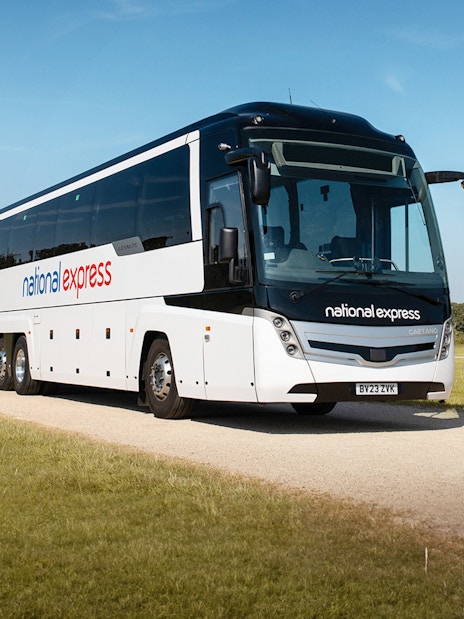 National Express bus traveling on a countryside road.