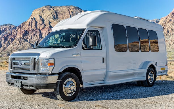Tour van parked with Grand Canyon backdrop, part of Maverick Aviation tour.