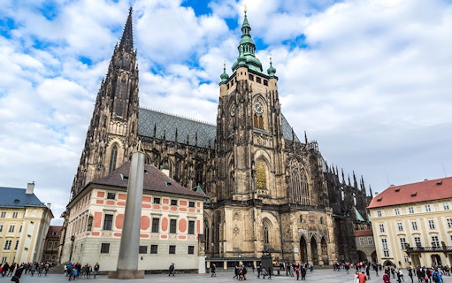 Prague Castle with tourists in courtyard during walking tour.