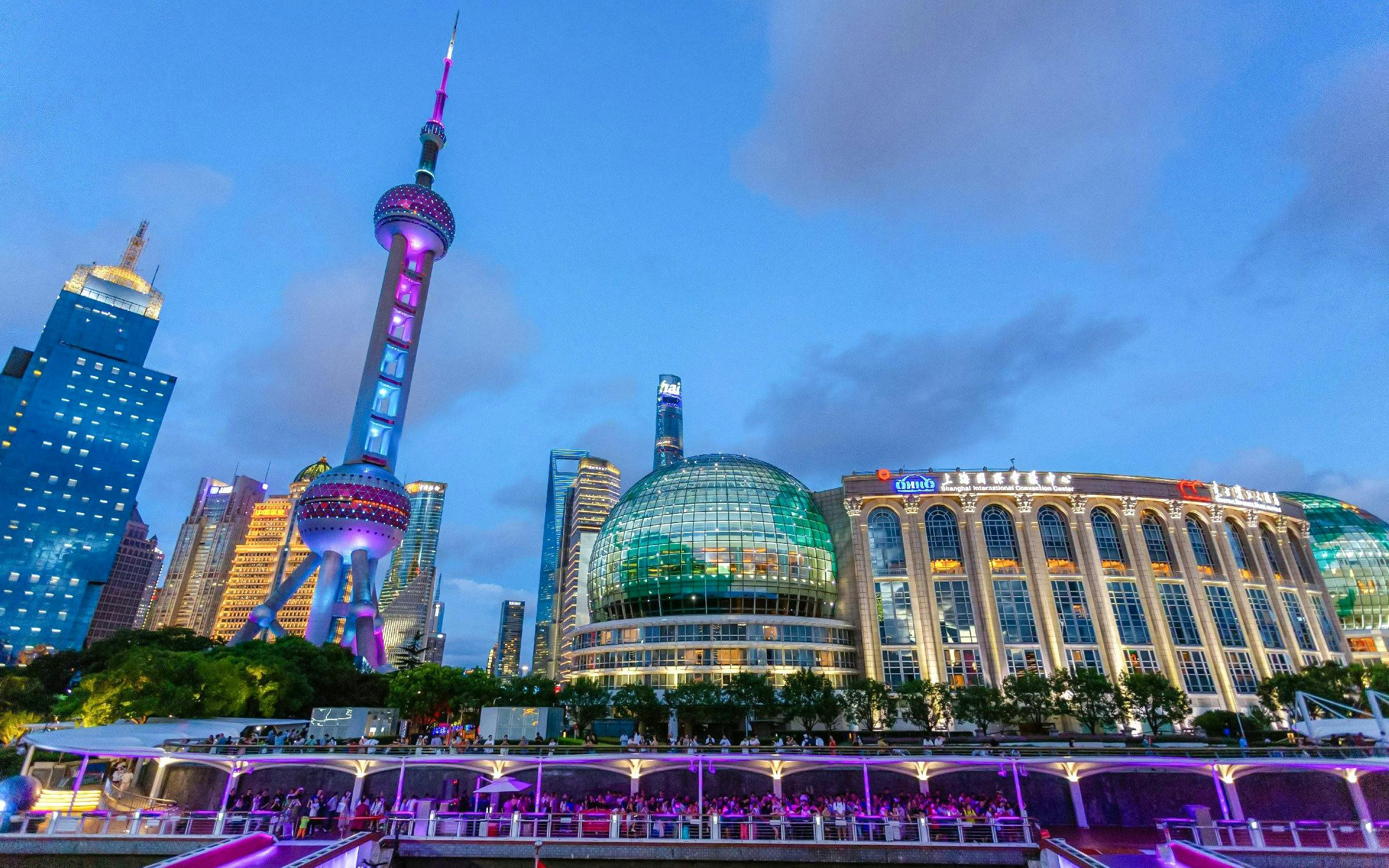 Oriental Pearl TV Tower illuminated on Shanghai skyline from Huangpu River.
