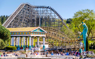 Roller coaster and Greek temple at Parc Asterix, France.