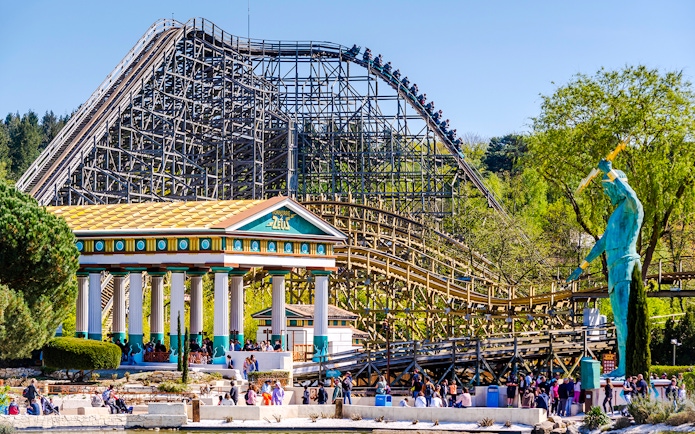 Roller coaster and Greek temple at Parc Asterix, France.