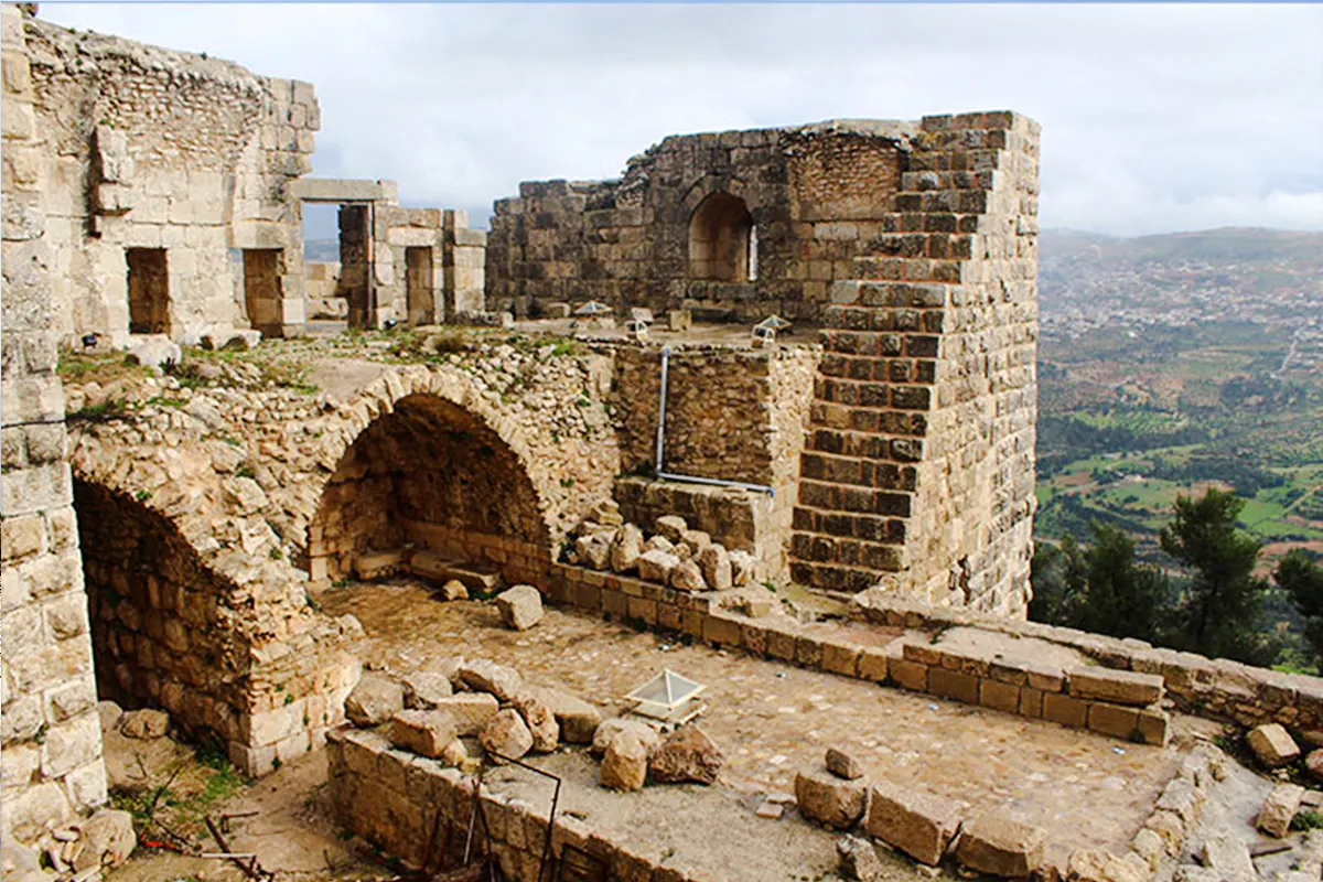 Jerash & Ajloun Castle ruins with stone arches and walls, view of Amman landscape.