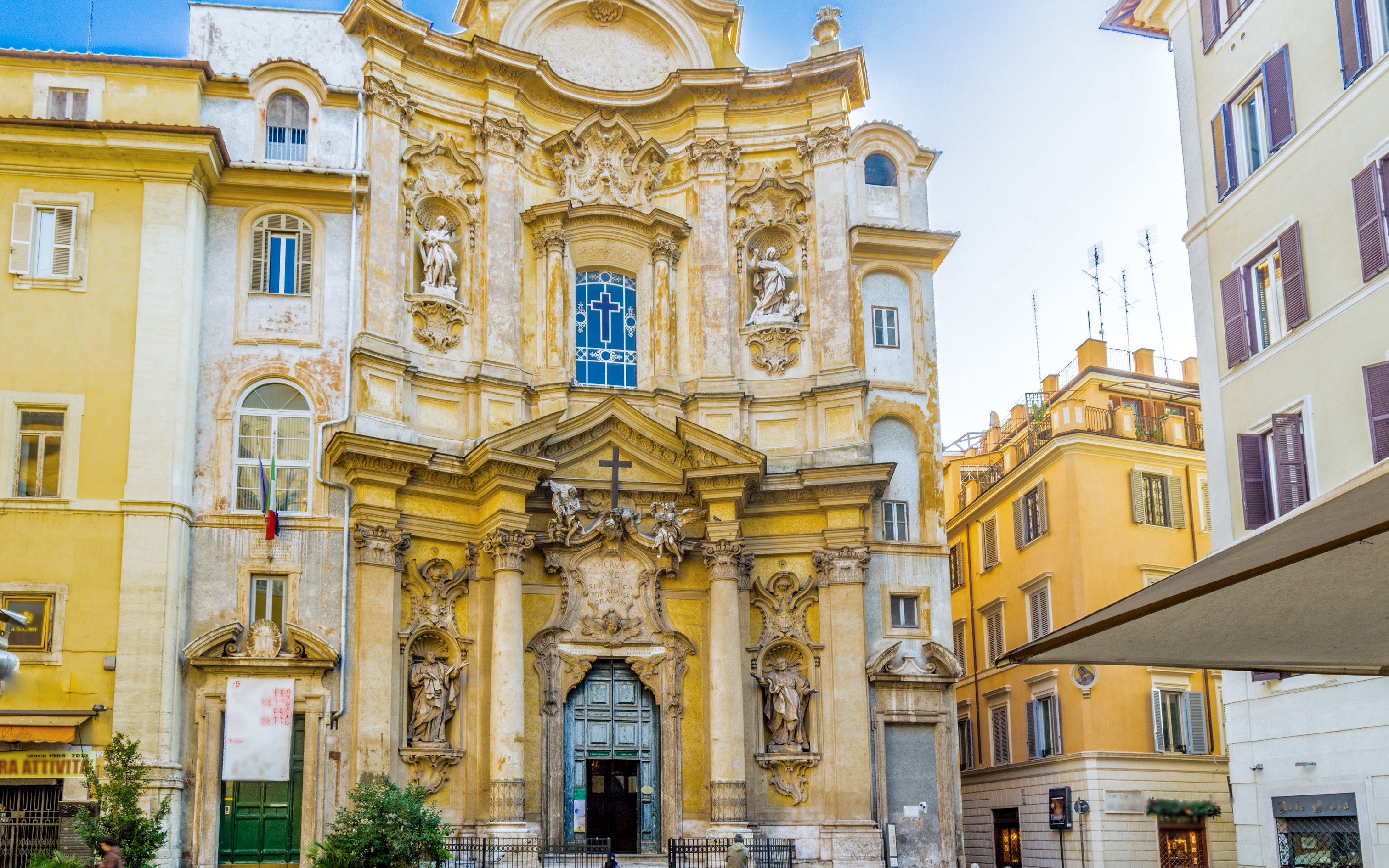 Saint Mary Magdalene Church facade with ornate sculptures, Rome, Italy.