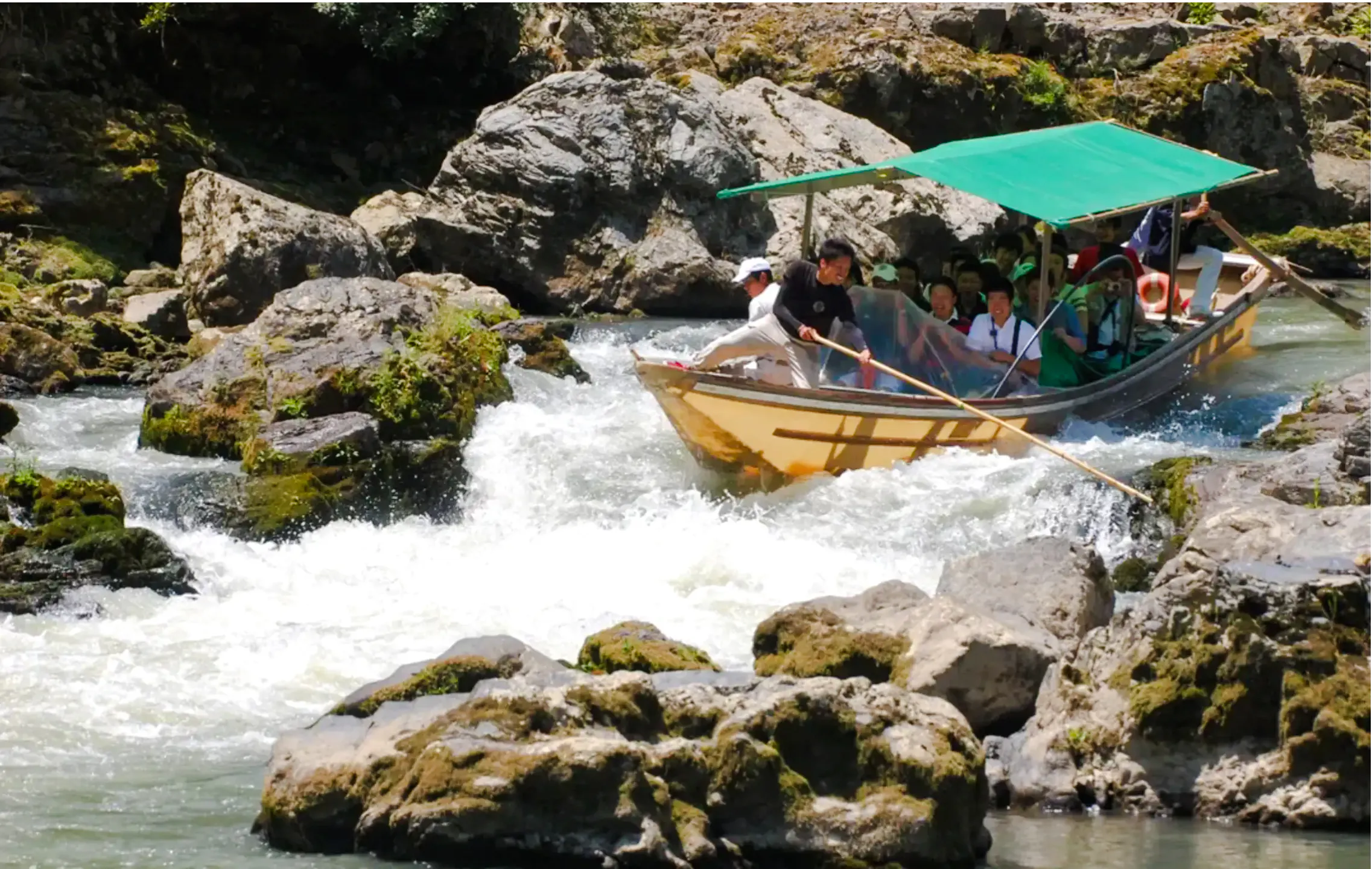 Boat navigating rapids on Hozugawa River during Kyoto day tour.