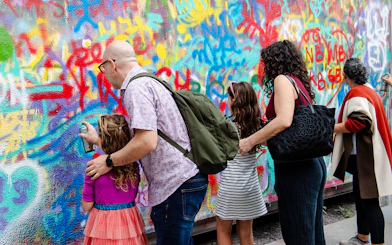 Visitors spray painting a colorful mural at Wynwood Walls Museum.