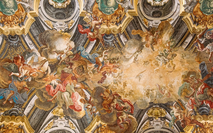 Fresco on the ceiling of Sansevero Chapel in Naples depicting angels and clouds.