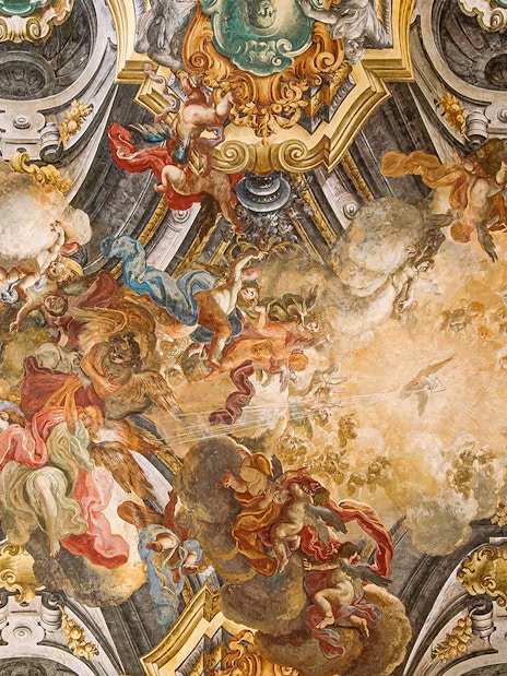 Fresco on the ceiling of Sansevero Chapel in Naples depicting angels and clouds.