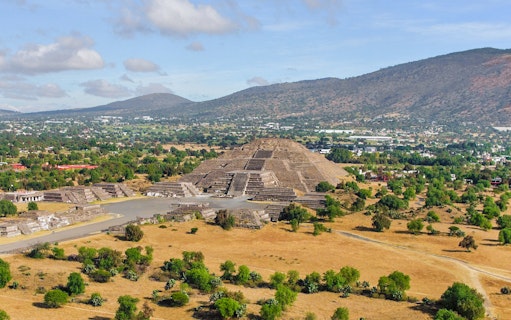 Pyramid of the Moon and Road of the Dead in Teotihuacan, Mexico, with surrounding landscape.