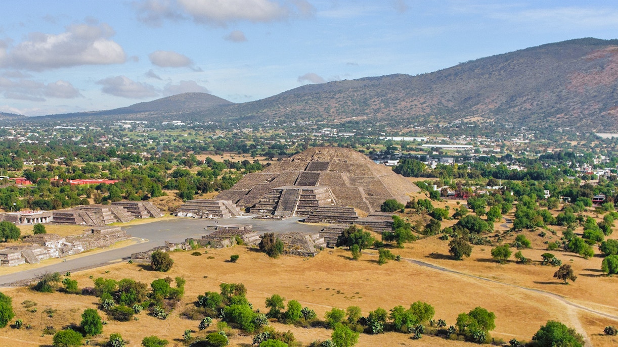 Pyramid of the Moon and Road of the Dead in Teotihuacan, Mexico, with surrounding landscape.