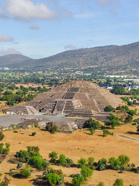 Pyramid of the Moon and Road of the Dead in Teotihuacan, Mexico, with surrounding landscape.