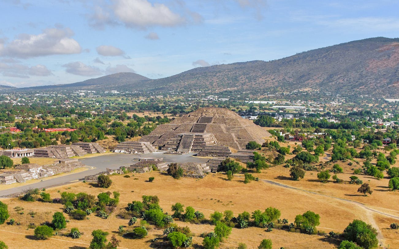 Pyramid of the Moon and Road of the Dead in Teotihuacan, Mexico, with surrounding landscape.