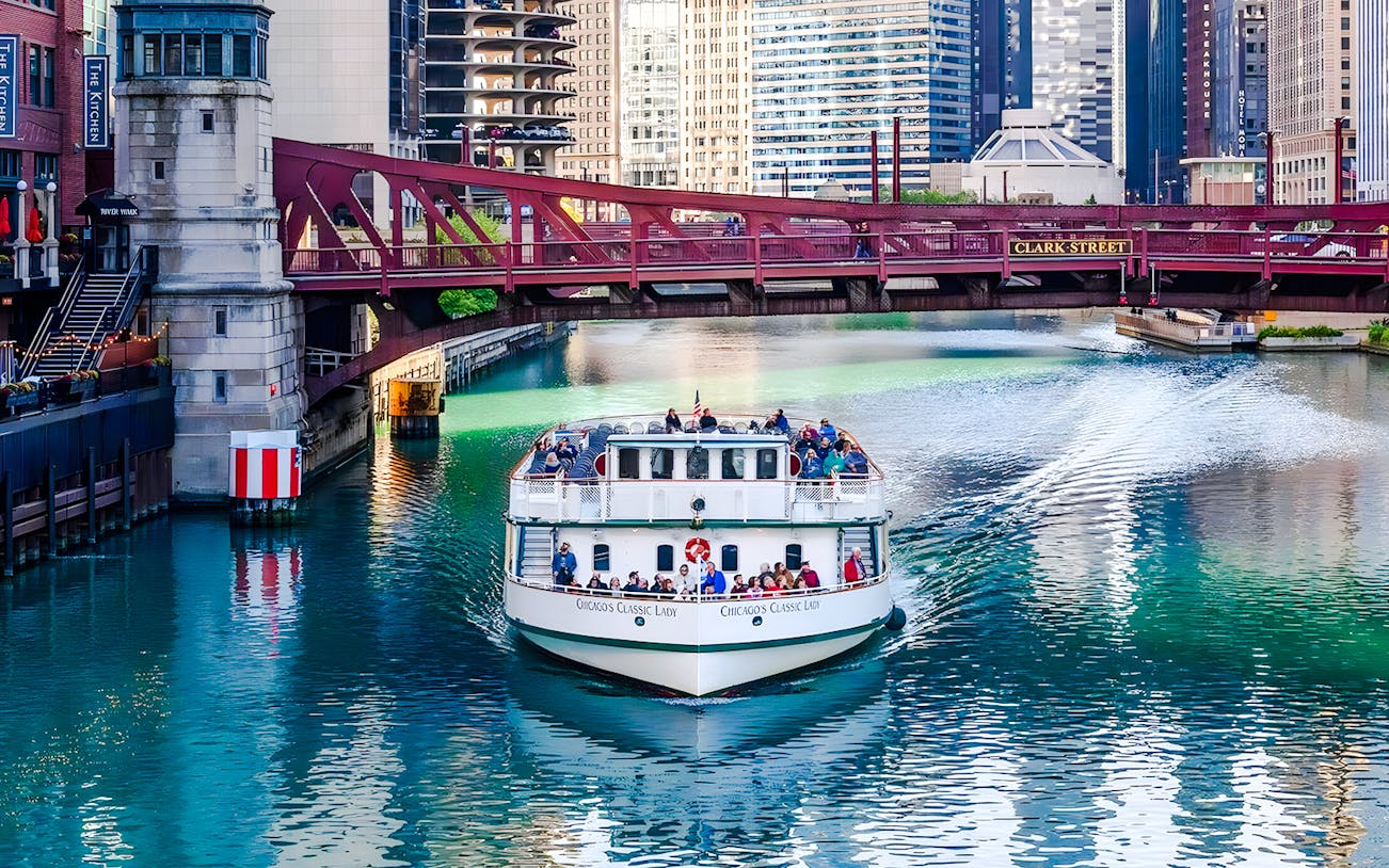 Cruise boat on Chicago River passing under Clark Street Bridge.