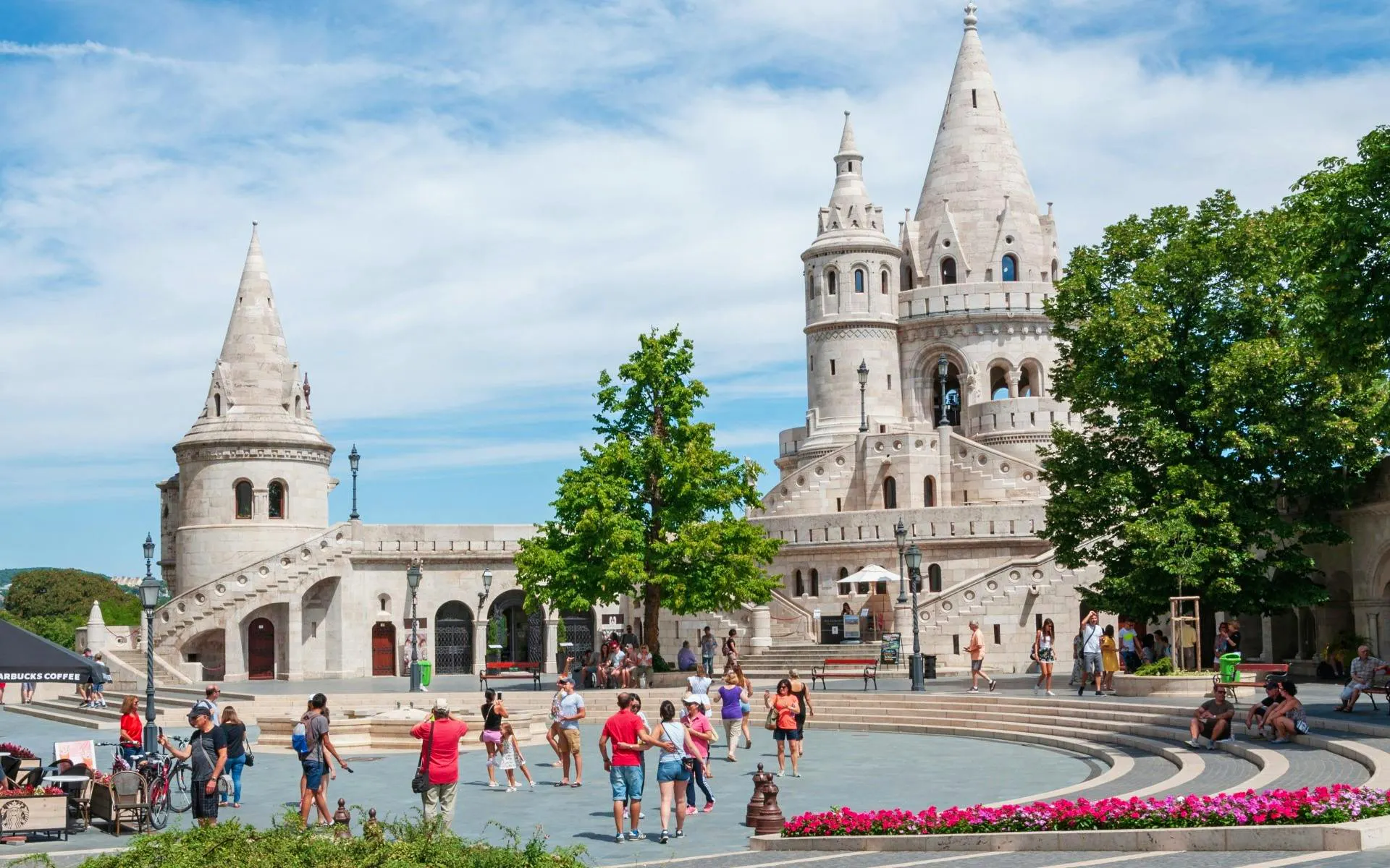 Fisherman's Bastion in Budapest's Castle District with tourists exploring the area.
