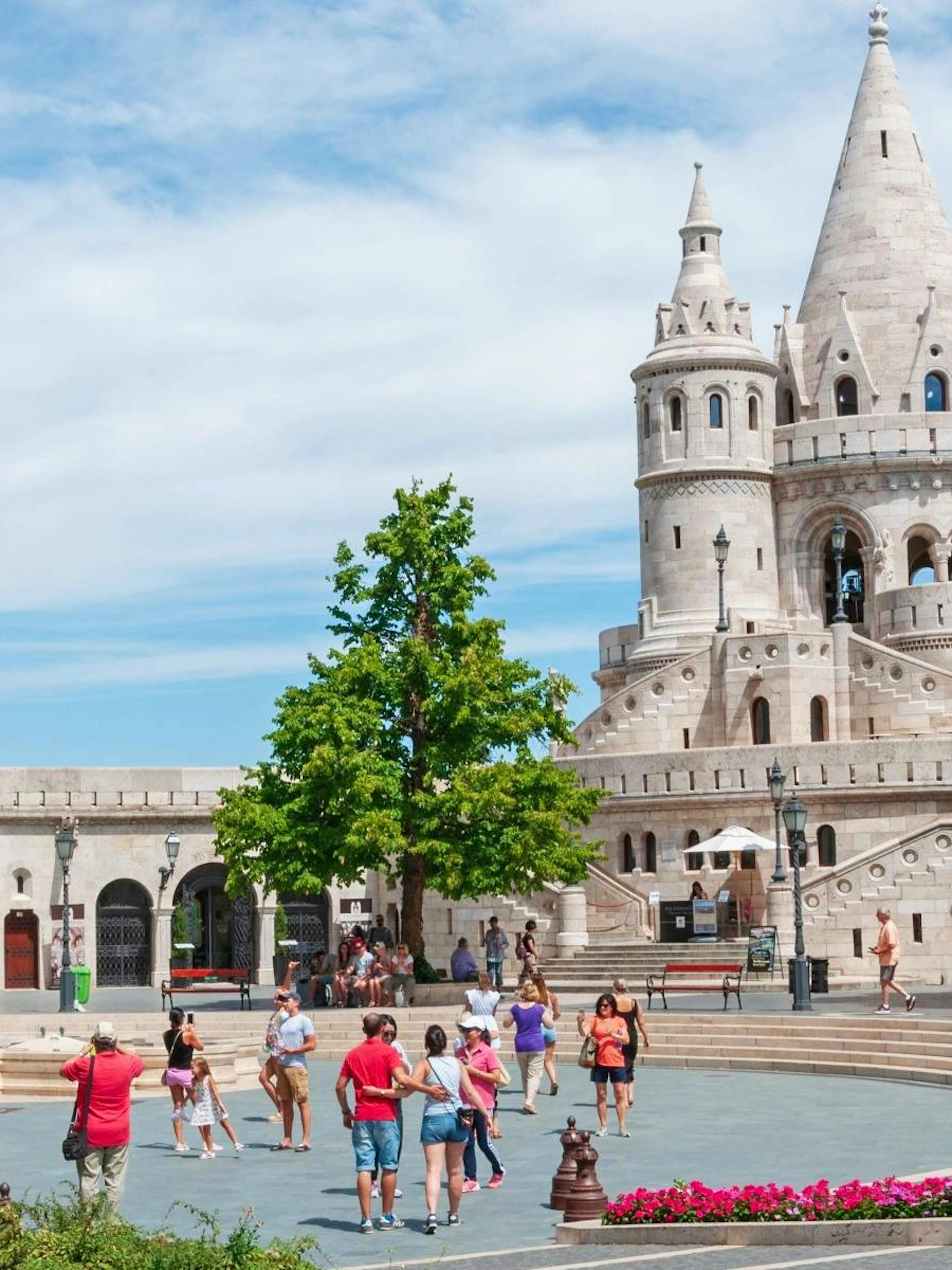 Fisherman's Bastion in Budapest's Castle District with tourists exploring the area.