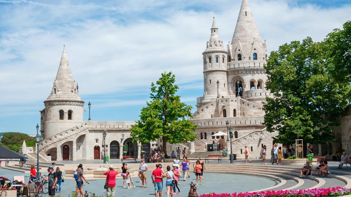 Fisherman's Bastion in Budapest's Castle District with tourists exploring the area.
