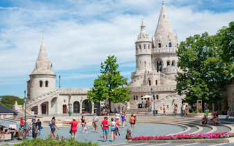 Fisherman's Bastion in Budapest's Castle District with tourists exploring the area.
