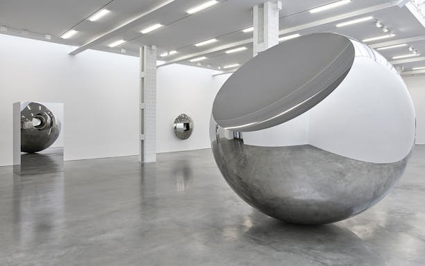 Reflective sculptures in Anish Kapoor's Untrue Unreal exhibition.