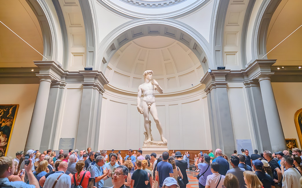Visitors viewing Michelangelo's David at Accademia Gallery, Florence.