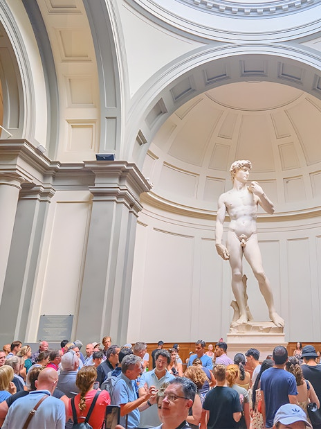 Visitors viewing Michelangelo's David at Accademia Gallery, Florence.