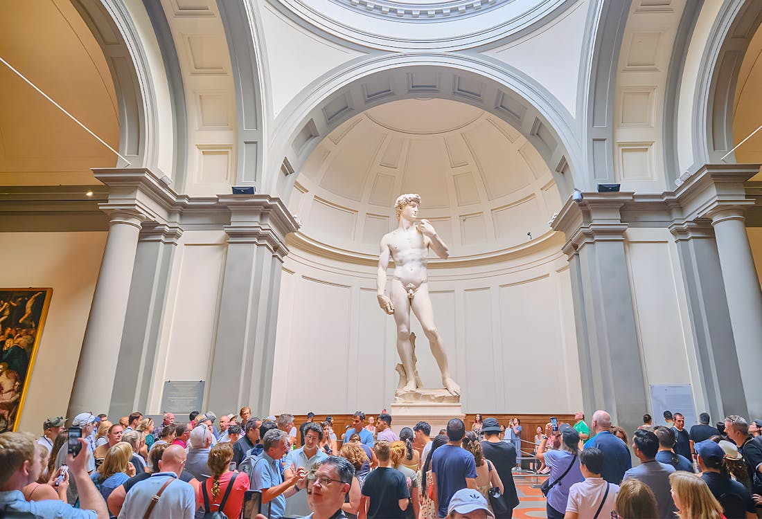 Visitors viewing Michelangelo's David sculpture at Accademia Gallery, Florence.