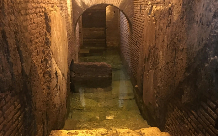 Trevi District Underground passage with ancient brick walls and water, Rome guided tour.