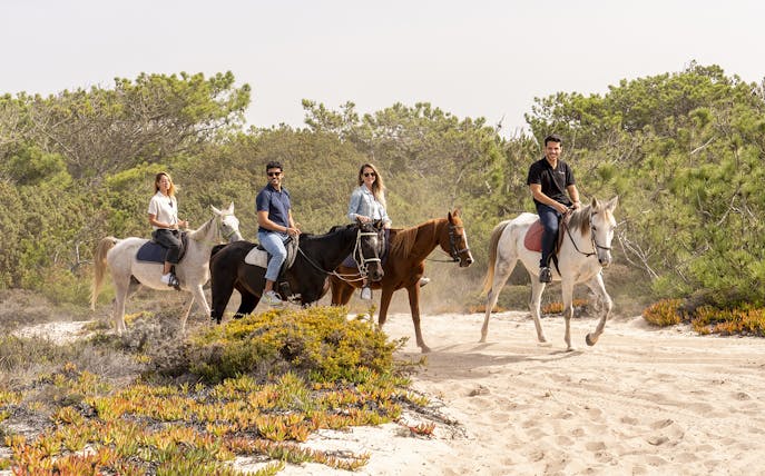 Horseback riders on a sandy trail in Comporta during a Lisbon to Setúbal city tour.