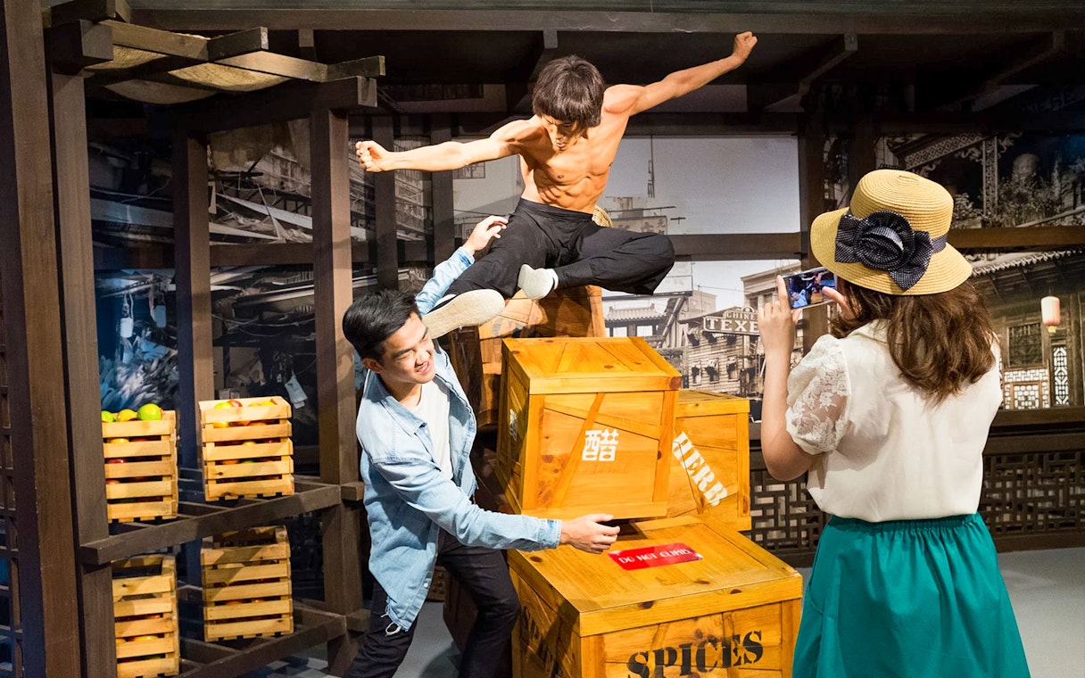 Wax figure of martial artist in action at Madame Tussauds Singapore.