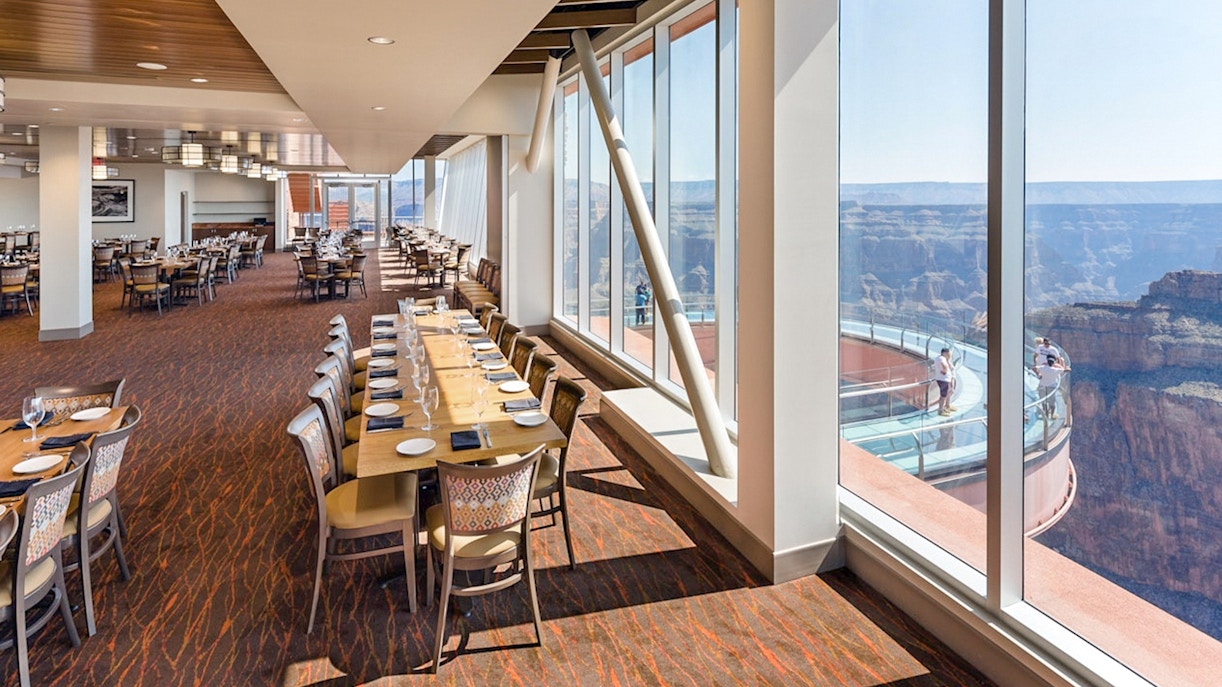 Helicopter flying over the Grand Canyon West Rim with scenic views of the canyon landscape.