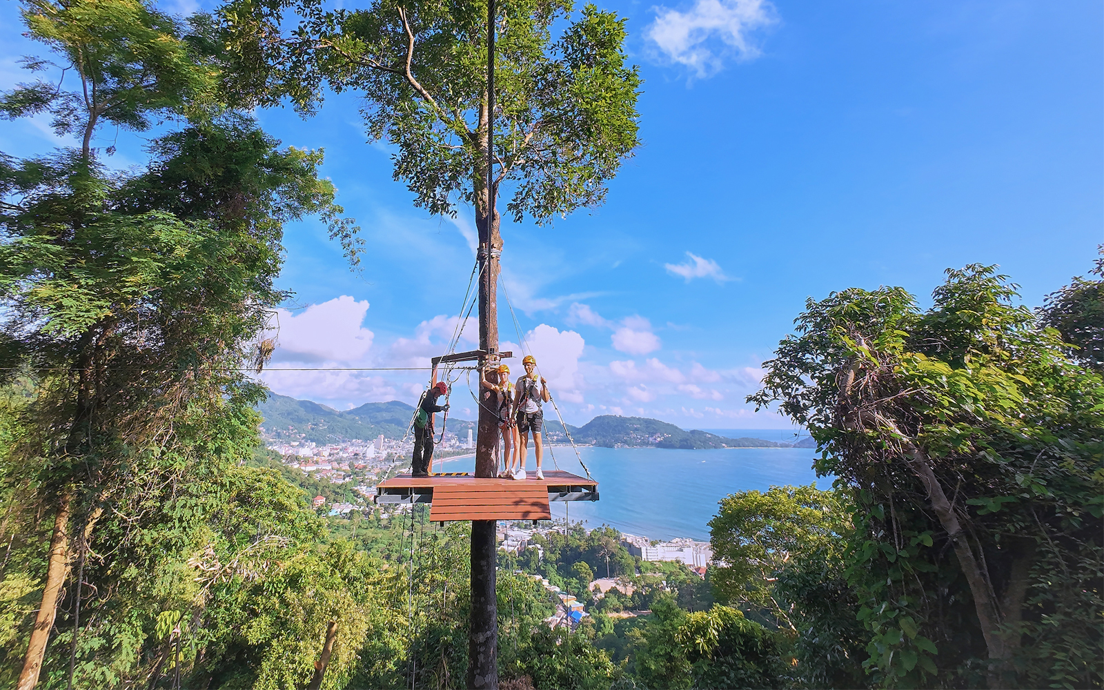 Ziplining platform with tourists overlooking Patong Bay, Phuket.