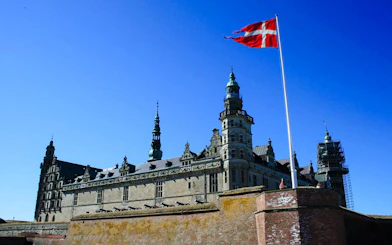 Kronborg Castle with Danish flag, Helsingør, Denmark.