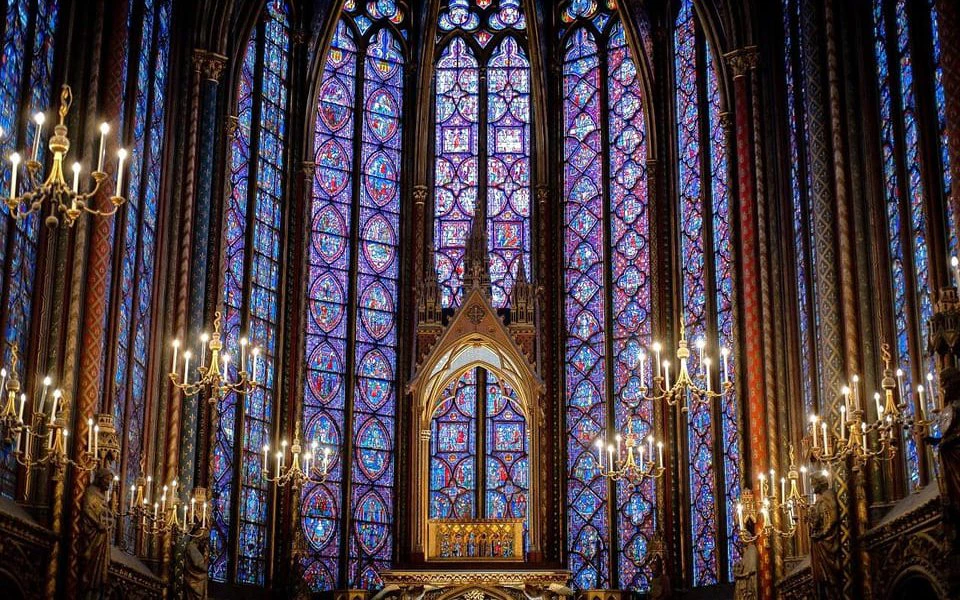 Stained glass windows inside Sainte Chapelle, Paris, during guided tour.