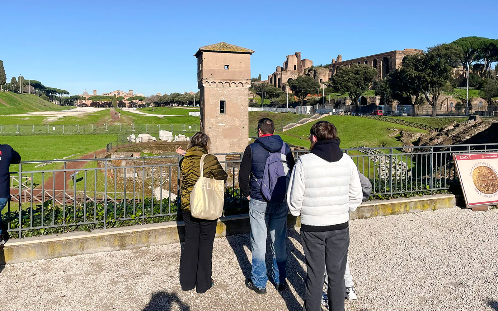 Visitors overlooking Circus Maximus archaeological site in Rome, Italy.