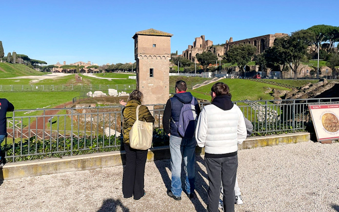 Visitors overlooking Circus Maximus archaeological site in Rome, Italy.