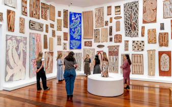 Visitors viewing Indigenous art at National Gallery of Victoria during Best of NGV Experiences Tour.